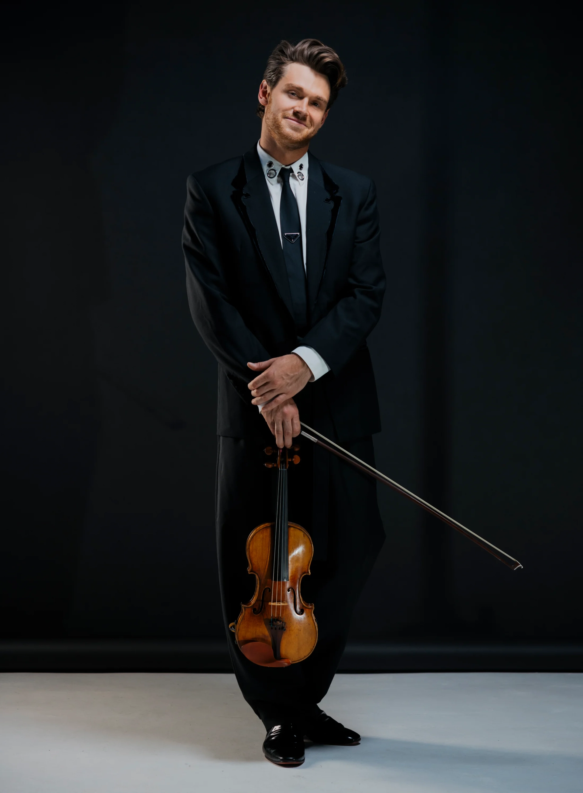Blake Pouliot in a formal portrait with his violin