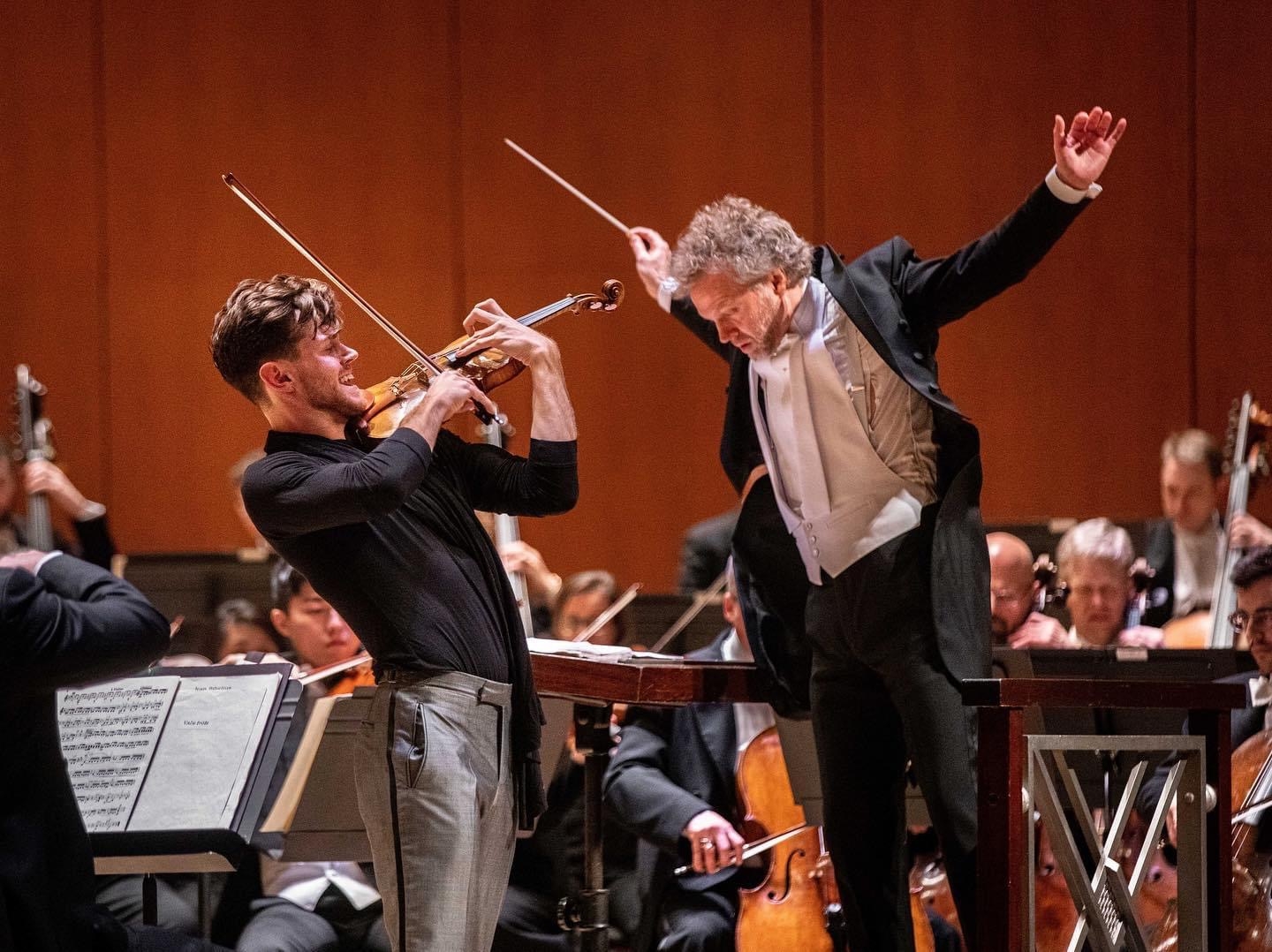 Blake Pouliot performing with a conductor and orchestra